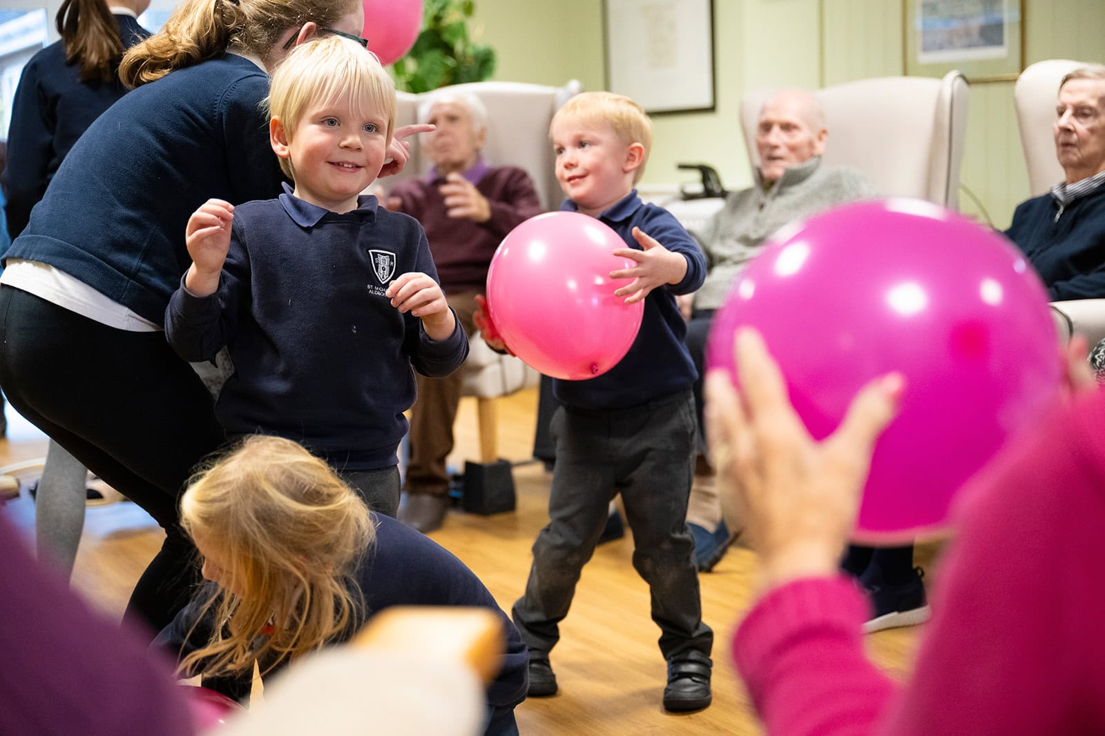 school children playing with the residents